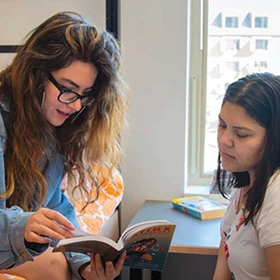 Two students talking in a residence hall room