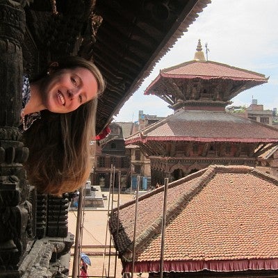 Olivia Molden looking out from a building in Asia.