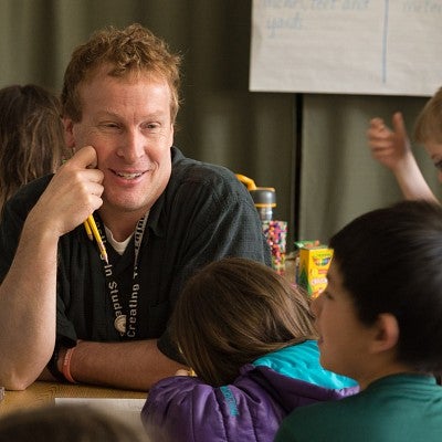 A UO educator with Edison students