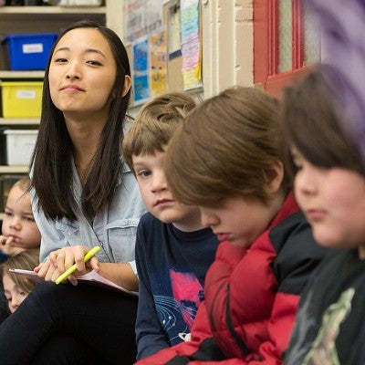 Teacher with three young students