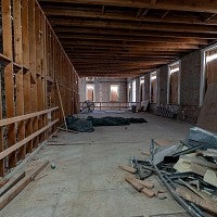 Both building interiors have been stripped down to studs and brick