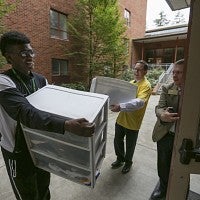 UO President Michael Schill helped with the hauling.