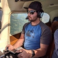 Pilot at controls of airplane