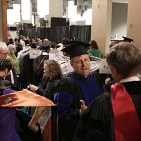 Faculty members picking up regalia