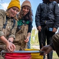 Students helping check fish