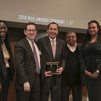 Institutional Transformation Award winner Michael Andressan (center)