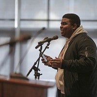 Student August Jefferson giving a spoken word performance