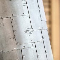 More than 1,000 aluminum tiles portray acutal lab notes and papers