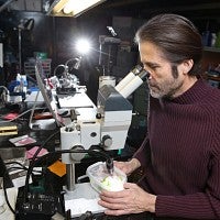 Robert Schofield at a microscope