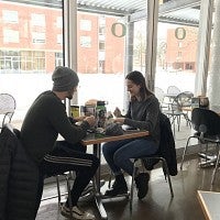 Students enjoy a meal indoors